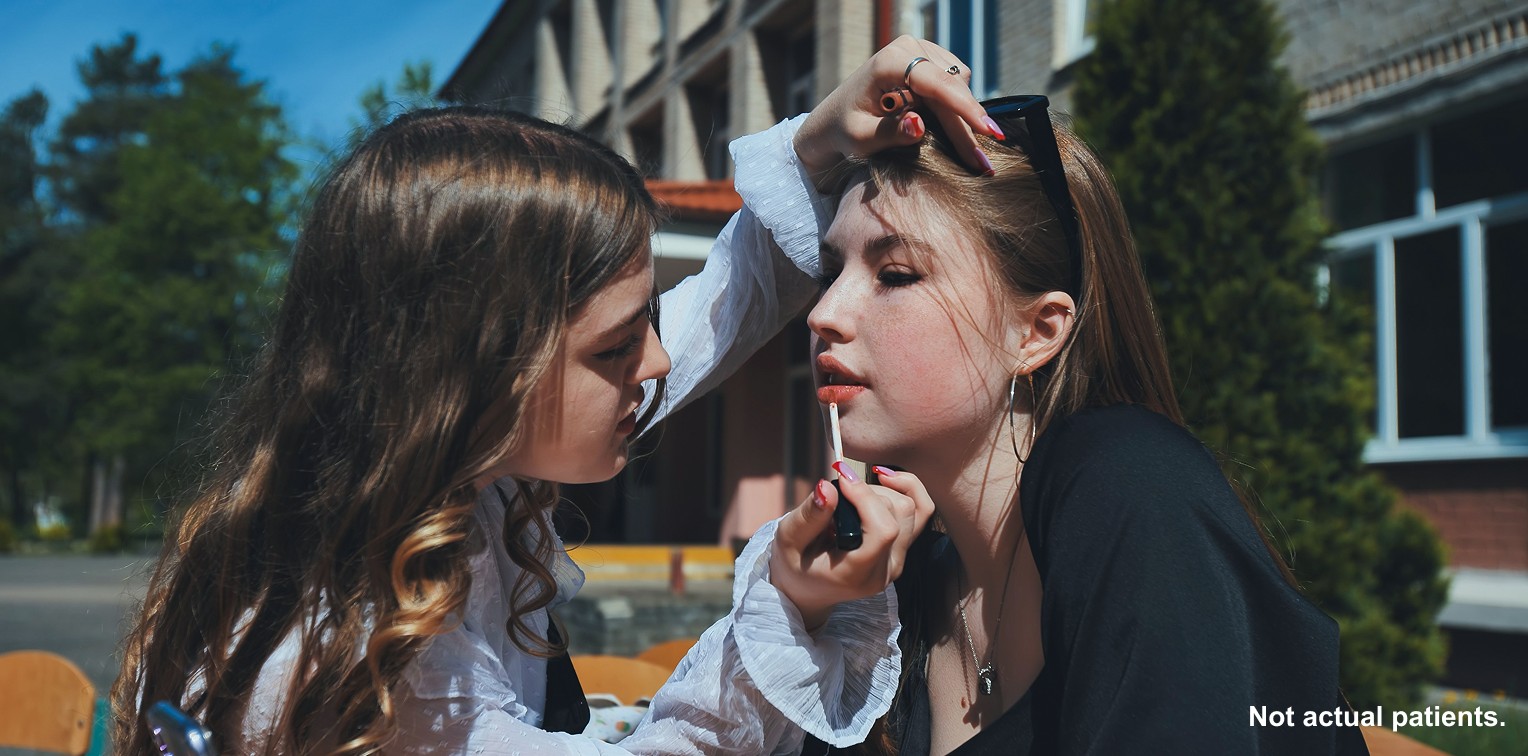Teens sharing lip gloss image