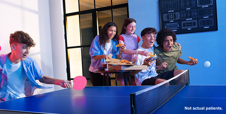 Five teens eating and playing image